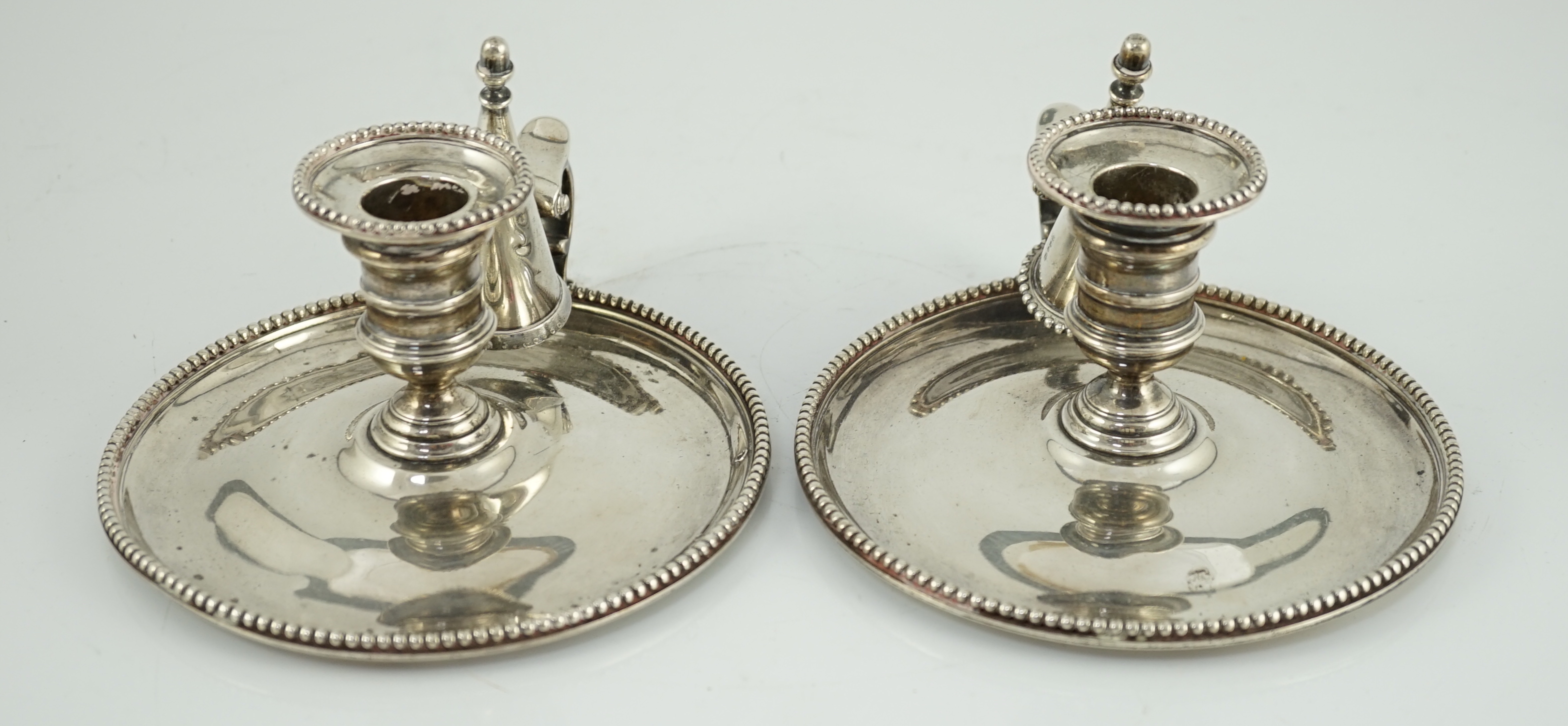 A pair of Victorian silver chambersticks and extinguishers, by Charles Thomas Fox and George Fox